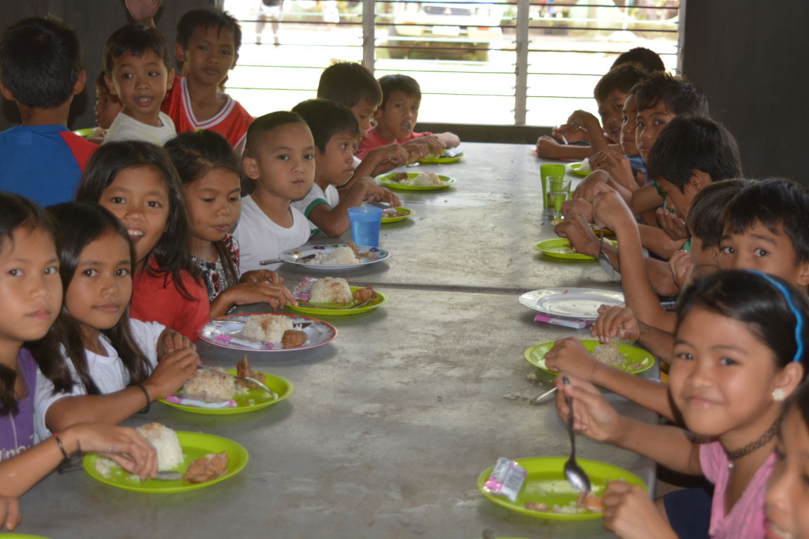 Children enrolled in our Philippine school lunch program enjoy a homemade lunch daily