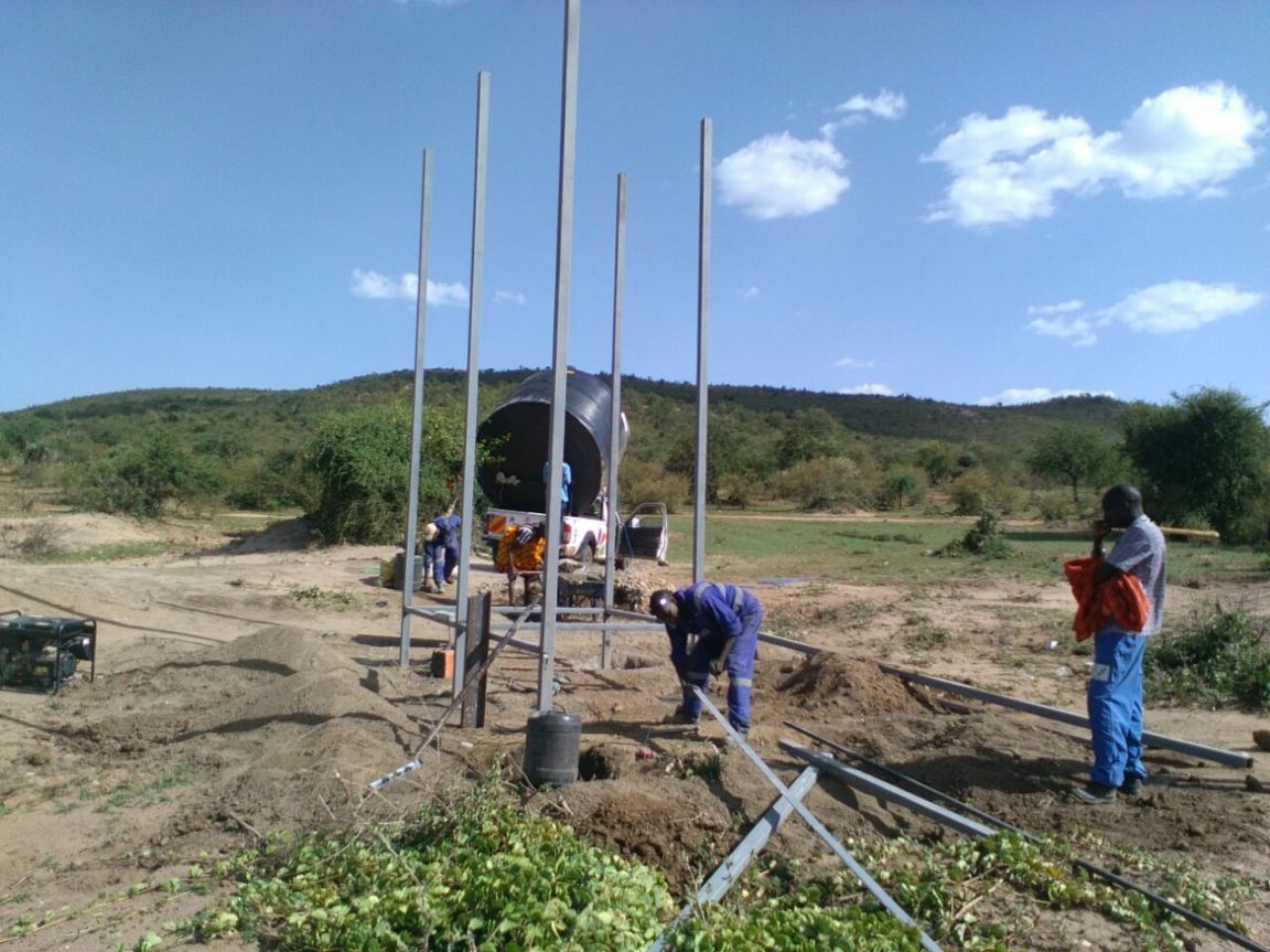 The crew works to assemble the stand that will hold the water storage tanks and solar panels used to pump the water at the borehole. Water quality and water scarcity is a serious problem in the Maasai Mara area of Kenya. We partner with local communities to provide clean water.