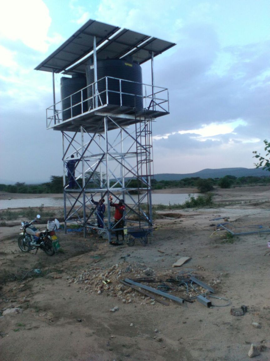 The crew works to install the solar panels that will power the pump at the borehole. Water quality and water scarcity is a serious problem in the Maasai Mara area of Kenya. We partner with local communities to provide clean water.