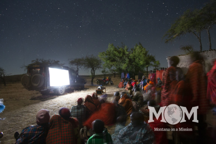 Maasai families gather to watch the story of Jesus in their own language for the first time. Montana on a mIssion partners with Life Ministries to share the word of God through the "Jesus" film and "Magdelena"