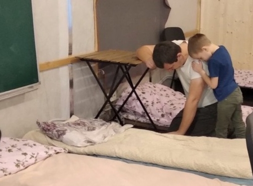 Refugees from the Ukraine pray next t their makeshift bed in a refugee shelter. Montana on a Mission is delivering funds to provide food and supplies for the refugees. 