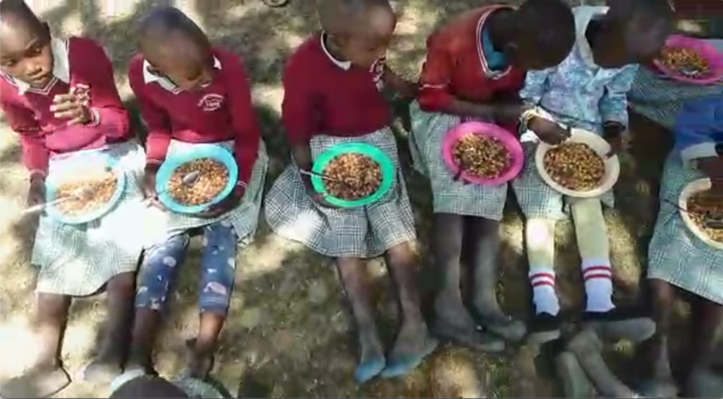 The new Kenya school year began two weeks ago and we are sharing in the excitement of the new Montana on a Mission school lunch program at the Lower Oloosekin school. The students are served a lunch of either maize and beans or rice and beans throughout the week with the addition of vegetables. Usually tomatoes, carrots, onions, potatoes, and greens. The students’ parents have come together to pay a mother to cook and clean up. Currently, the cost is about 50 cents per student per day. We will be reassessing and making any necessary adjustments to the quantity of food needed at the end of each month. We also expect the enrollment to rise as news reaches other families that their children can receive a hot, nutritious meal each day at school. Enrollment was about 35 students before we drilled the clean water well there in late 2020 and now is near 60 students. Over the past year we built a new building with two additional classrooms, latrines, hand washing stations and desks for the teachers and students. We were also able to help provide the government required curriculum. The school currently includes preschool through grade 2. Most of these schools add a grade per year as students advance.